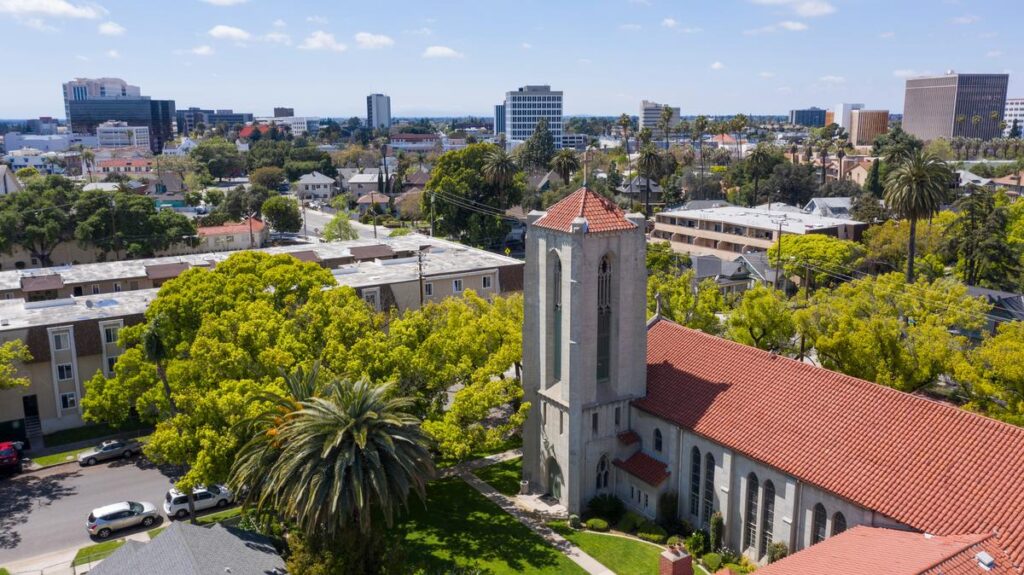 Aerial view of Santa Ana, California, showcasing urban buildings, lush greenery, and historic architecture